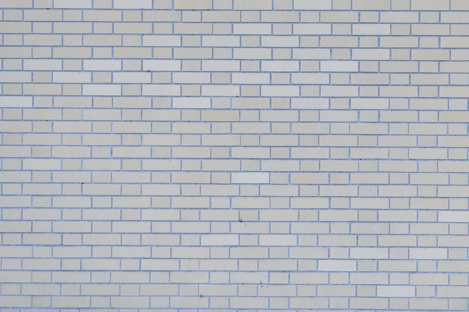 A full-frame image of a seamless white brick wall texture, perfect for backgrounds and architectural designs.